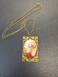 Gold tone porcelain pendant