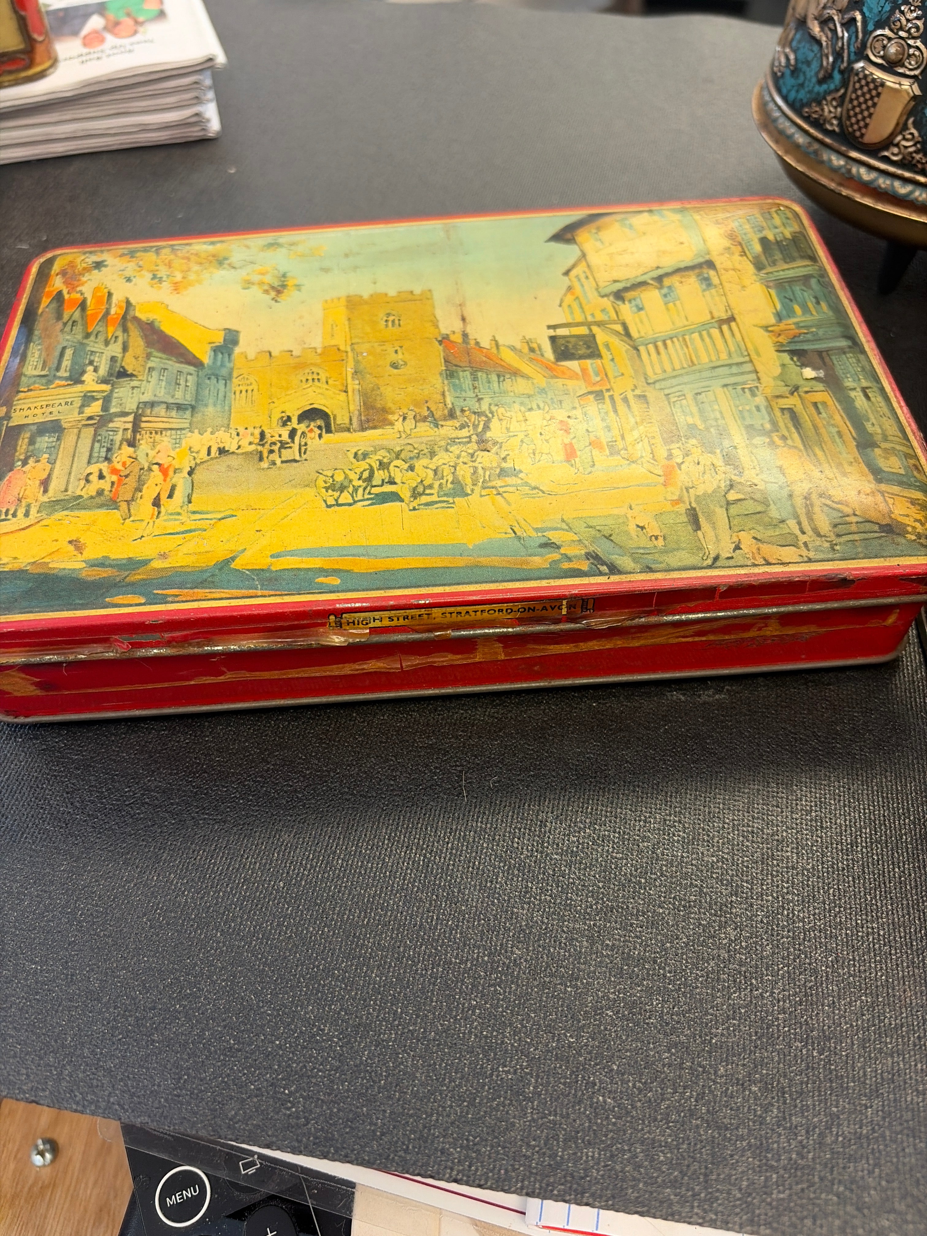 John Fitton & Co. "Sweets of Purity" advertising tin from Manchester, England, featuring an illustration of High Street in Stratford-on-Avon.