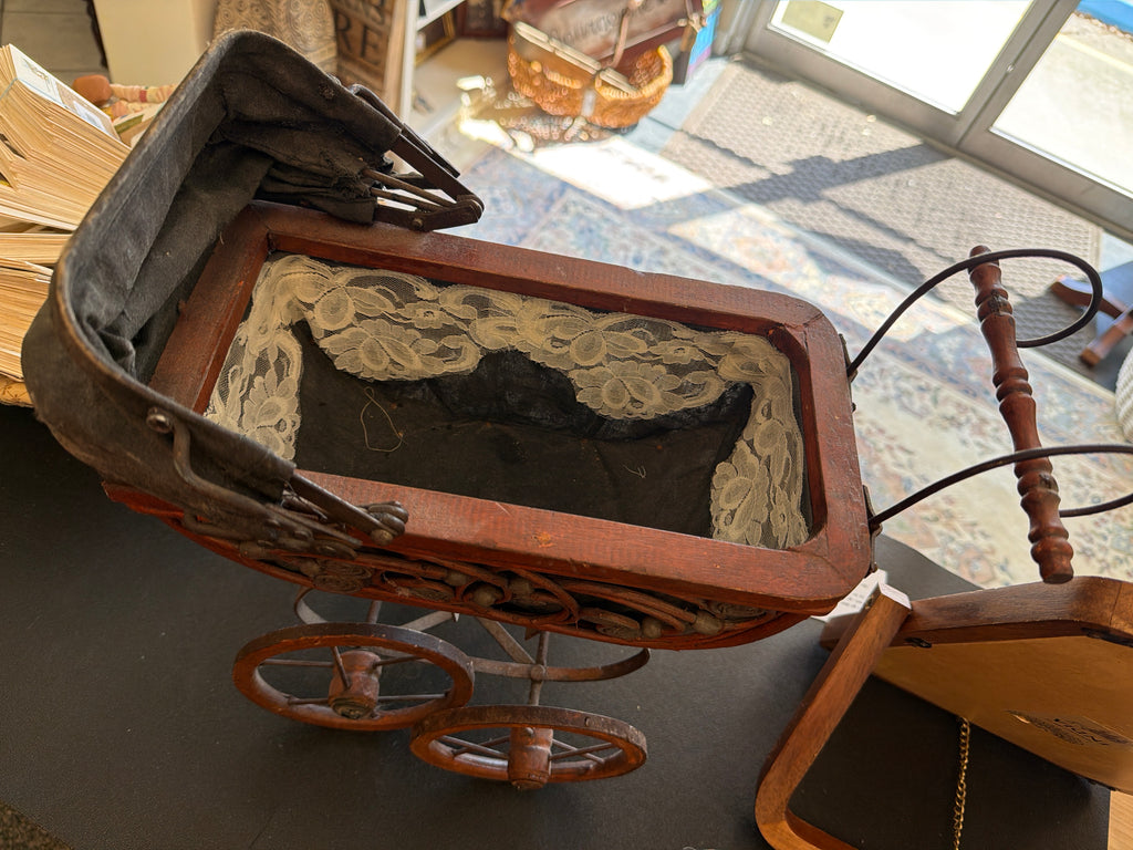 Antique Victorian-style doll pram.