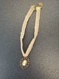 Vintage Robert Rose choker features a cream crochet band and a gold-tone pendant
