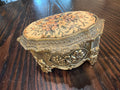 Vintage gold-toned metal and needlepoint or cross-stitch floral trinket/music box