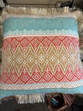 Throw pillow features a vibrant Southwestern-inspired tribal geometric pattern