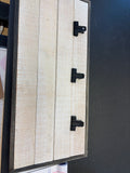 whitewashed wood clipboard wall panel, rustic vertical plank design accented with three attached black metal binder clips and a dark gray metal frame.