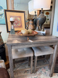 Rustic gray wood counter-height dining set with upholstered beige stools. 5 piece