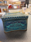 Vintage Edgeworth smoking tobacco tin with distinctive blue art deco graphics and concave, pinched sides