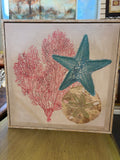 Stupell Industries Sea Life Trio on Beige Framed Canvas Wall Art by Amber Sterling, featuring a sparkling coastal arrangement of a blue starfish, sand dollar, and pink cora