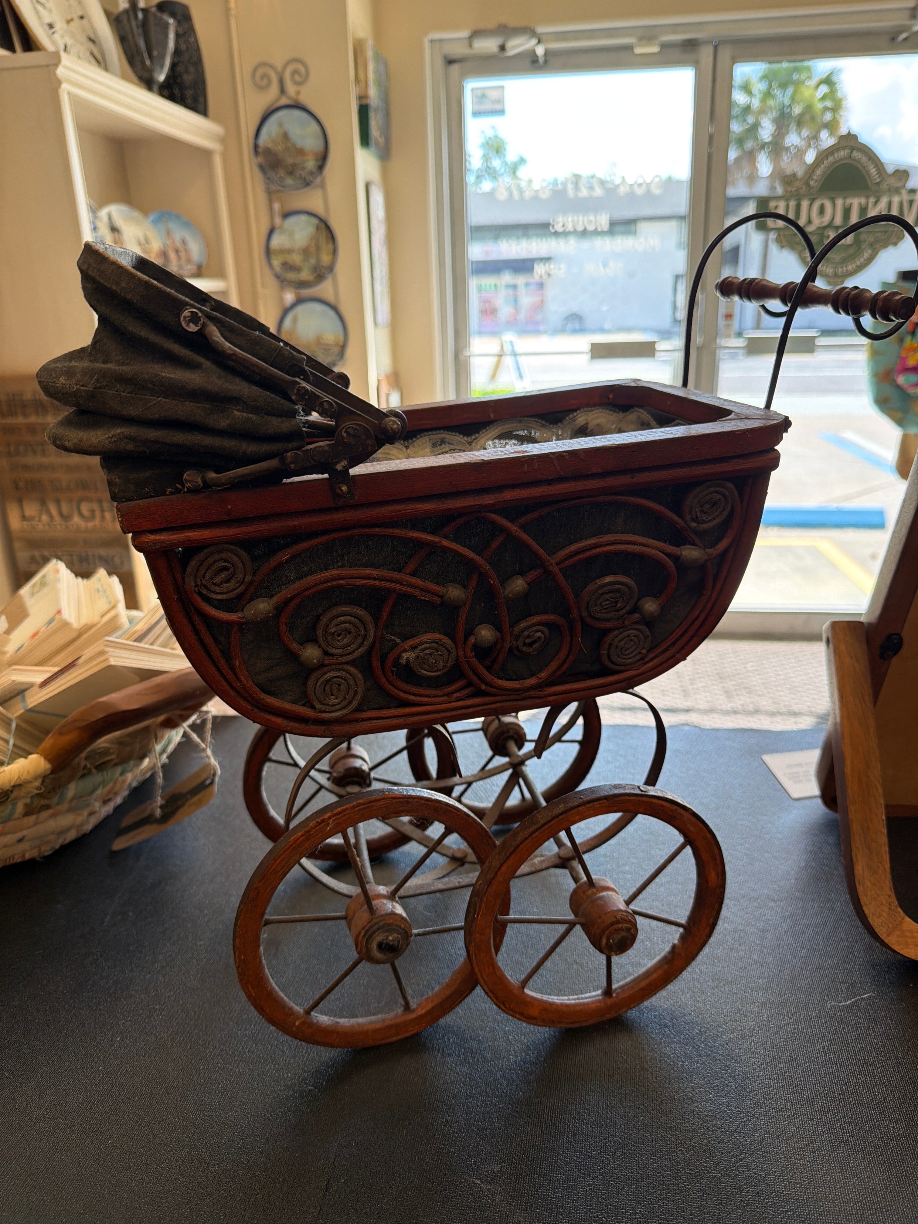 Antique Victorian-style doll pram.